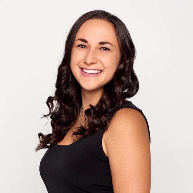 A smiling woman in a black top.