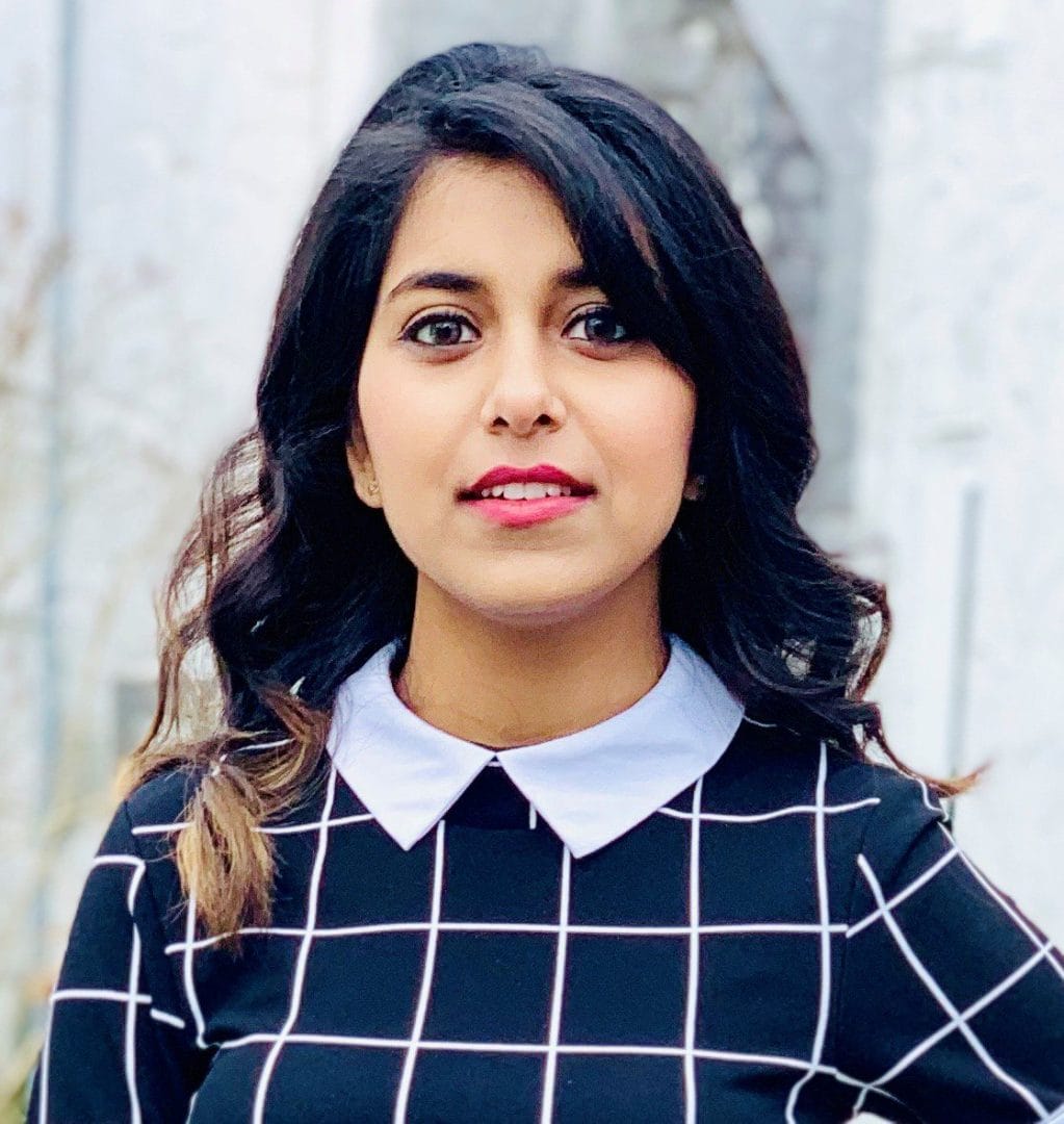 A woman wearing a black and white checkered shirt.