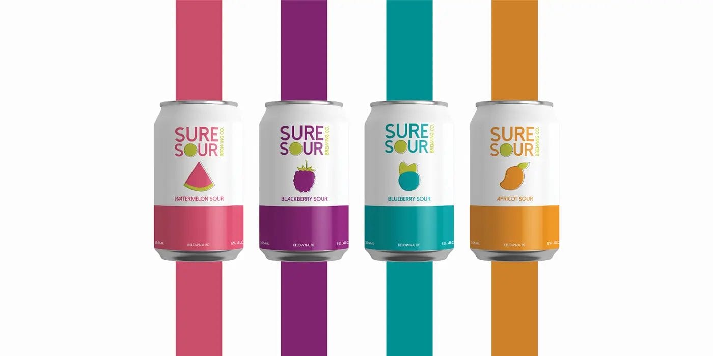 Four cans of juice with different colors on them.