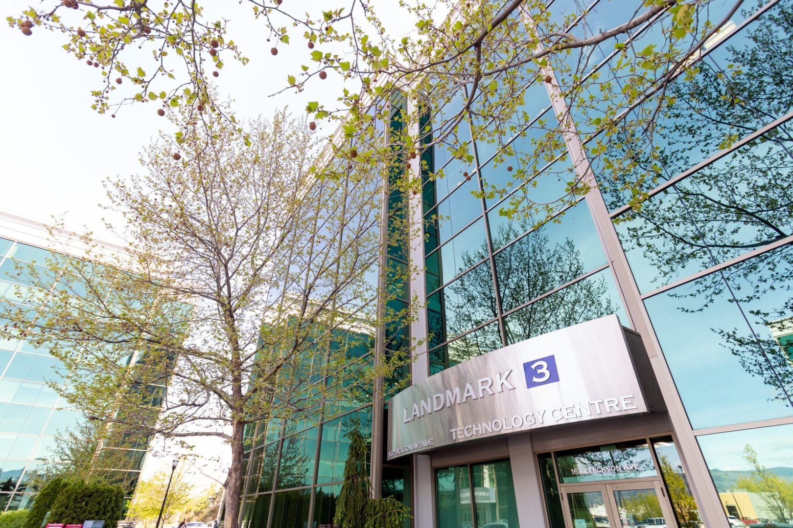 The entrance to a large office building with glass windows.