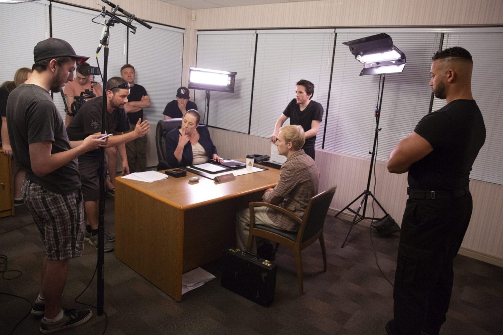 A group of people gathered around a desk.