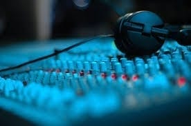 A close up of a blue sound mixing board.