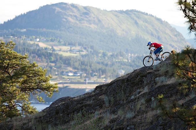 A person riding a mountain bike on a rocky hillside.