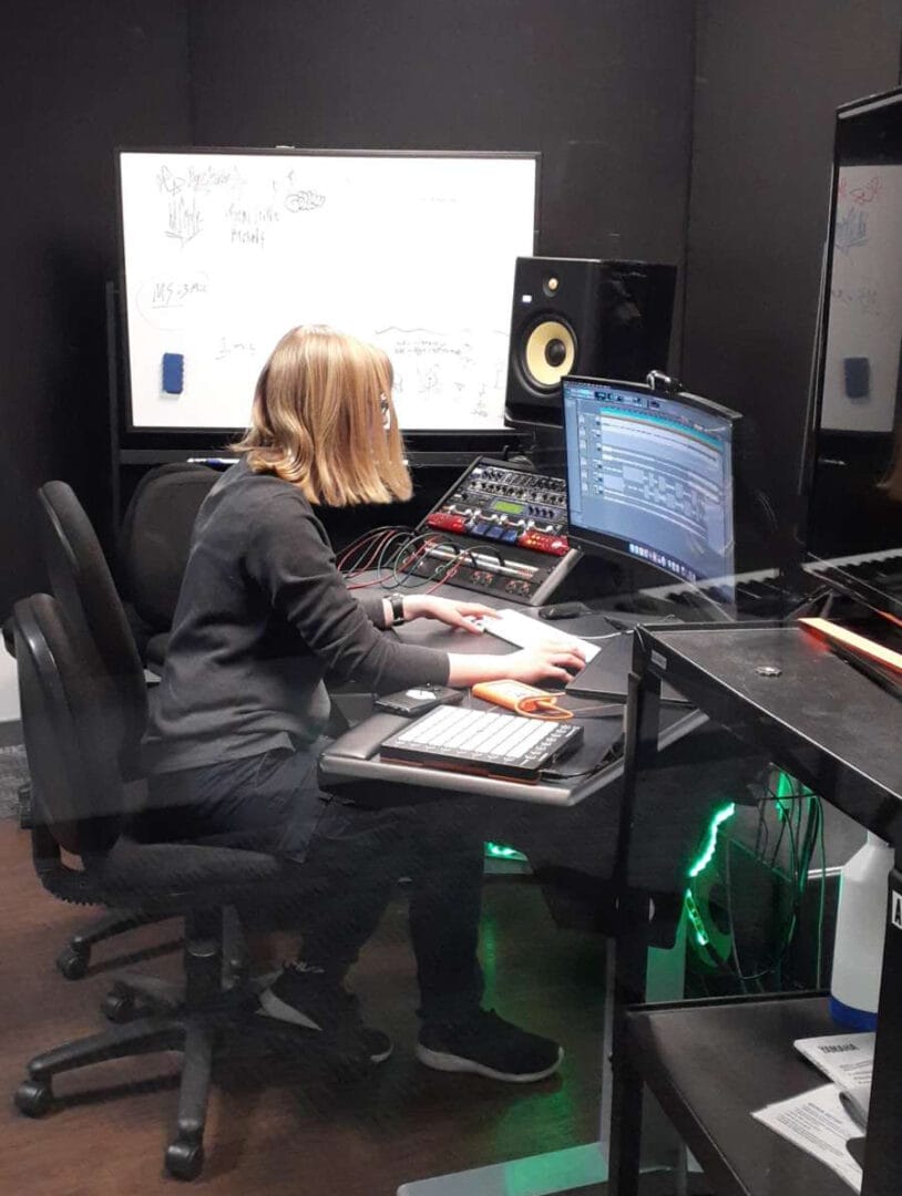 Audio Engineering & Production Grad, Sam McElroy working in an audio studio space.  